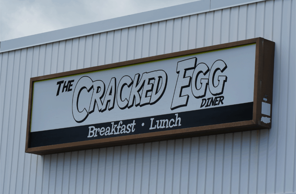 The Cracked Egg Diner exterior sign with blue sky background in Daytona Beach