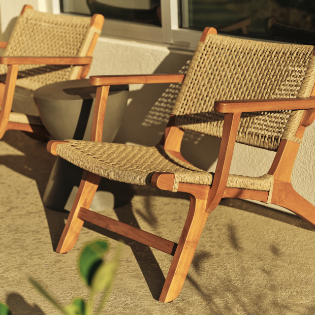 Sunlit rattan chairs on a private balcony at Ambros Hotel in Daytona Beach